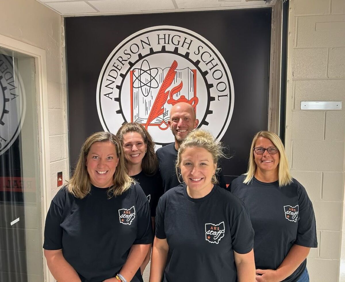 The Anderson counseling staff in front of the school seal